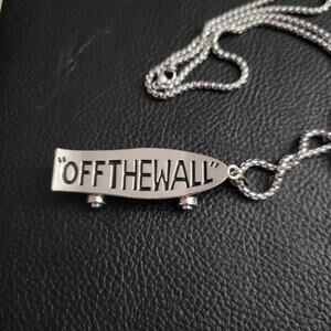 Vans logo "Off The Wall" stainless steel skateboard necklace, moving wheels